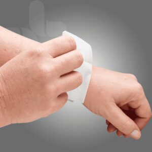 Hand using an AeroWipe alcohol-free cleansing wipe on skin