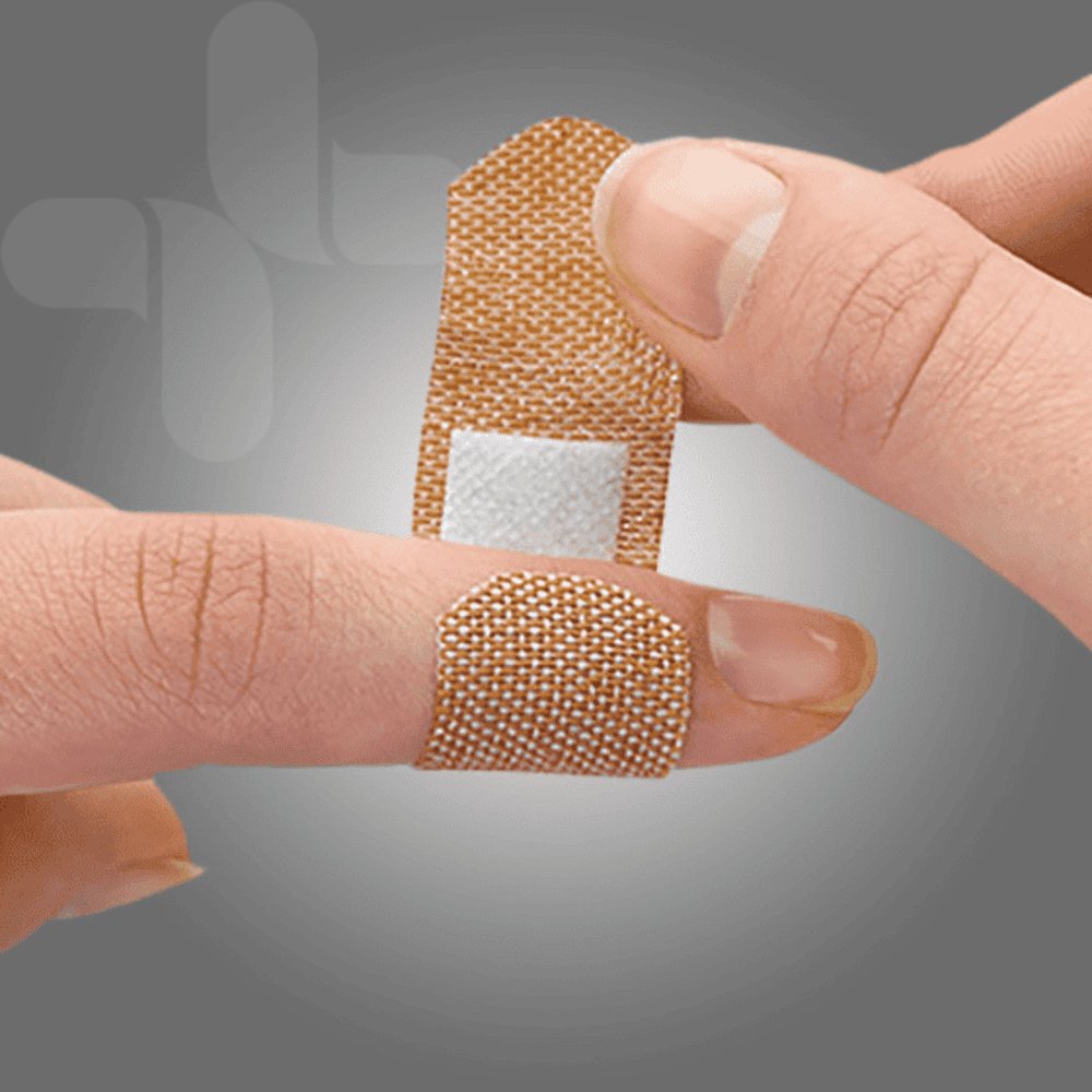 Close-up of an AeroPlast fabric bandaid strip wrapped around a fingertip, showing the non-stick pad